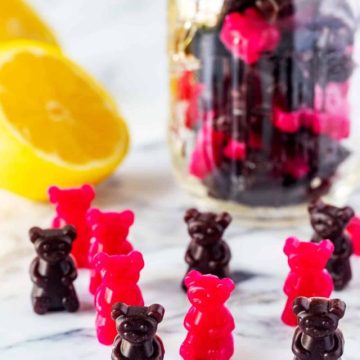 Side photo of keto gummy bears with a mason jar full of gummy bears behind it.