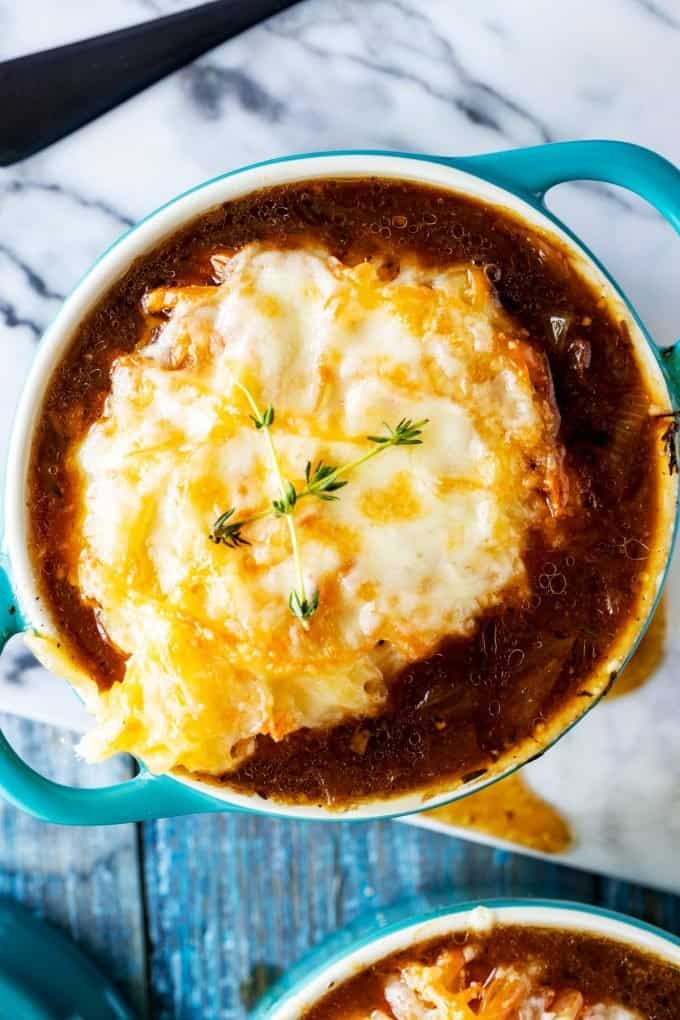 Overhead photo of a blue crock with keto french onion soup.