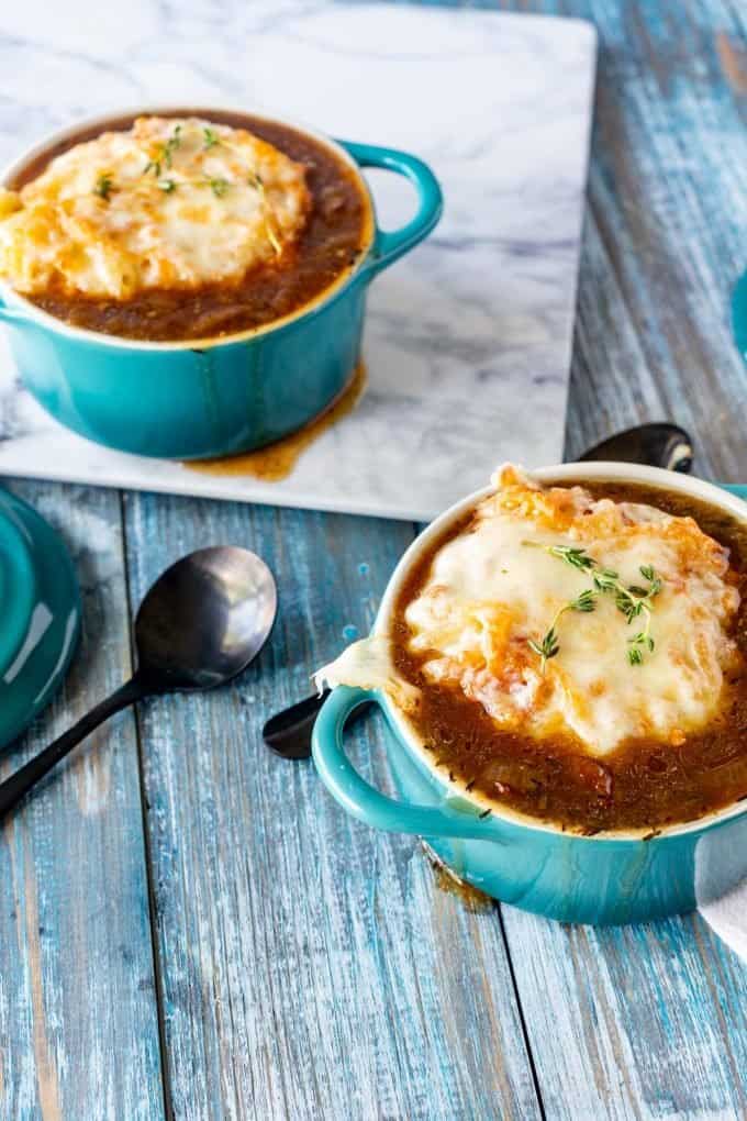 Side photo of a blue crock with keto french onion soup.