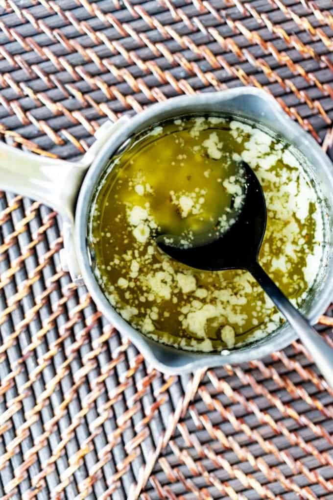 Photo of a small saucepan of garlic butter.