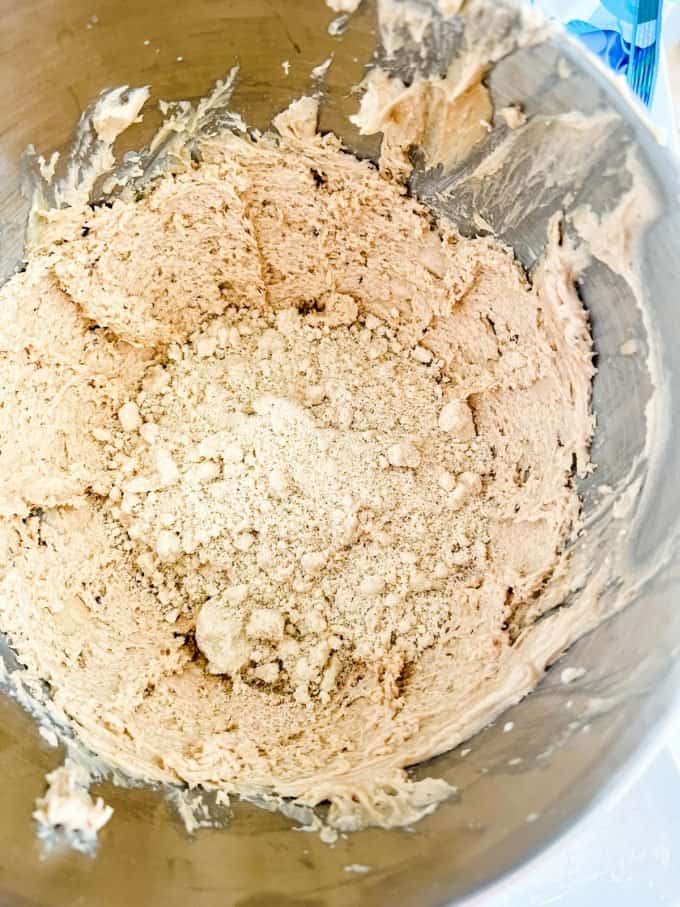 Photo of almond flour being added to keto cookie dough.