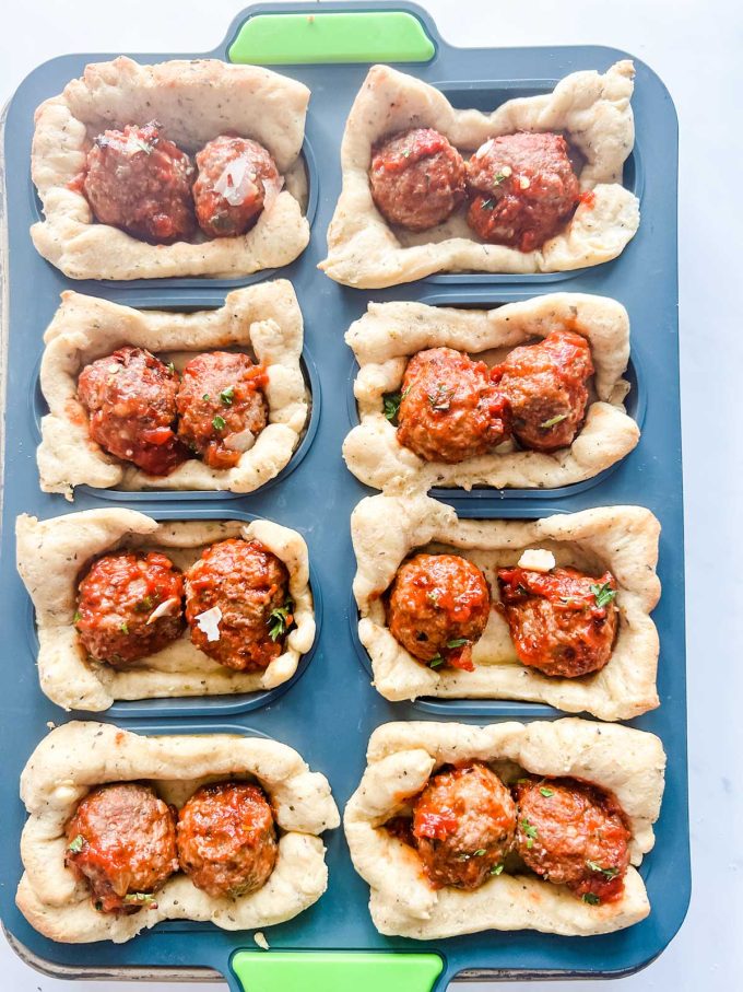 Partially cooked fathead dough with meatballs inside.
