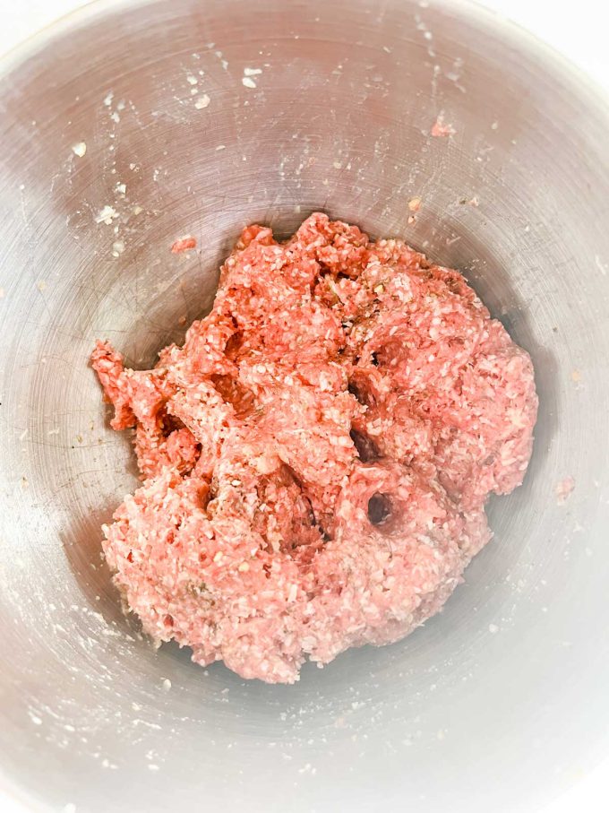 Photo of a meatball mixture in a bowl.