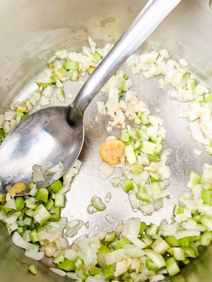 Photo of garlic that has been added to a pan of onions and celery.