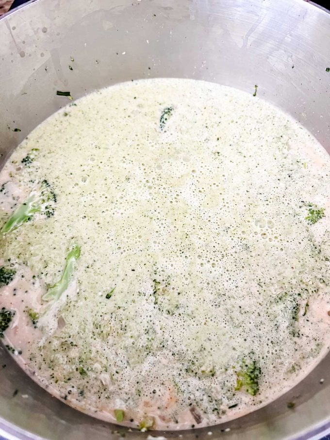 Keto Broccoli Soup that has had half of it blended and poured back into the soup pot.