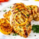 Square photo of grilled lemon pepper chicken.