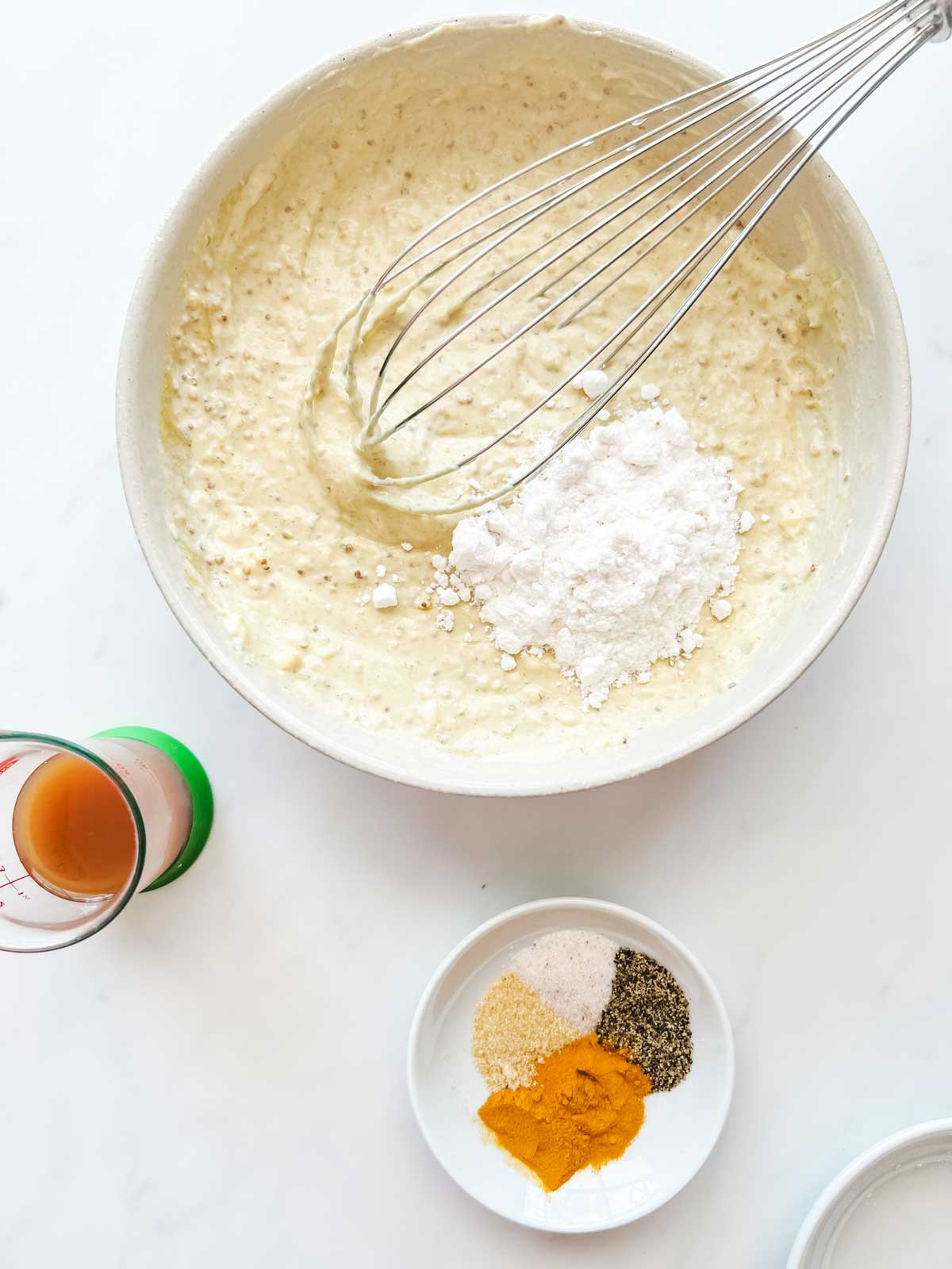 Overhead photo of a bowl of a mustard mayo mixture having sugar-free sweetener whisked into it.