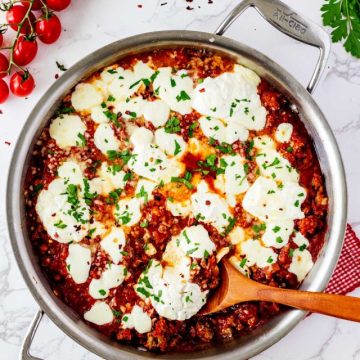 Overhead photo of a keto lasagna skillet with a spoon in it.