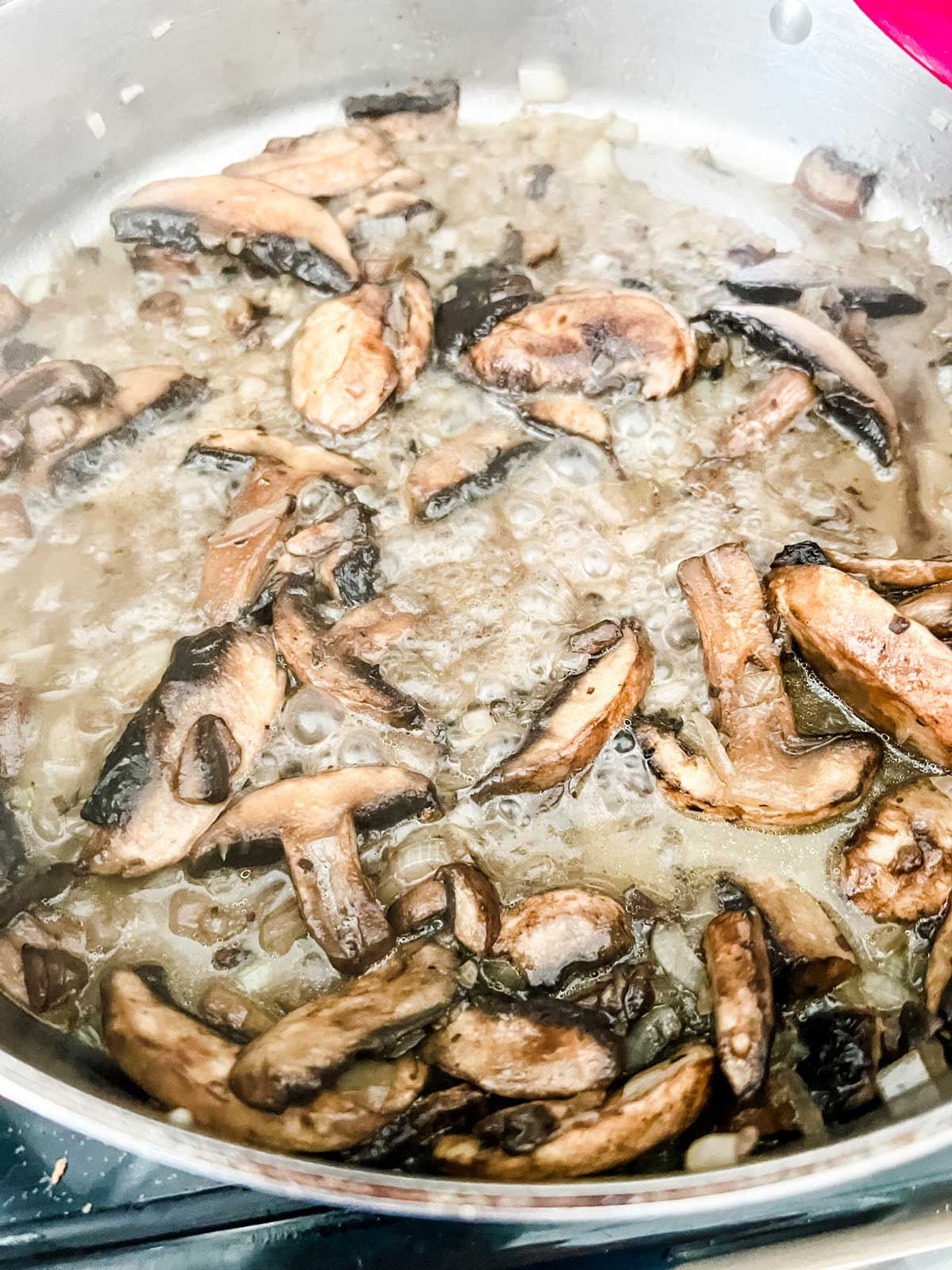 Photo of sauteed mushrooms and onion sin a skillet.