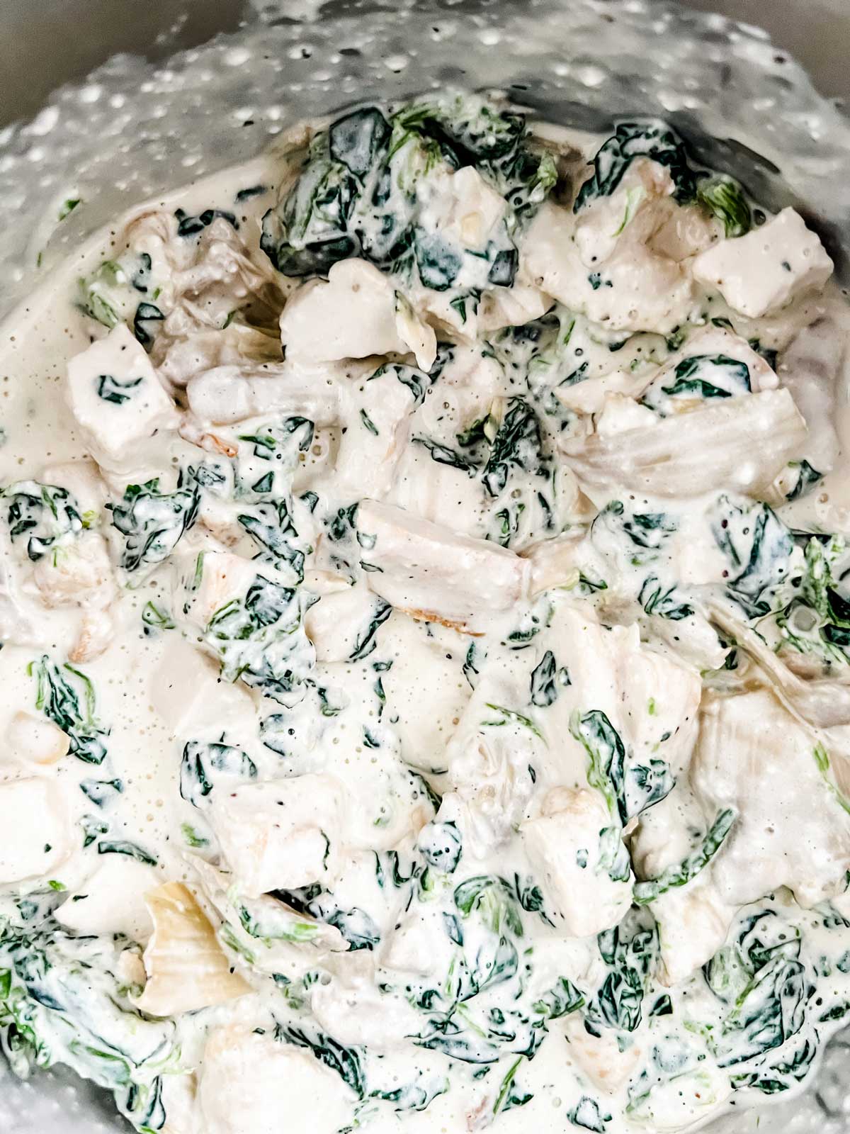 Photo of chicken and spinach in a cream sauce.