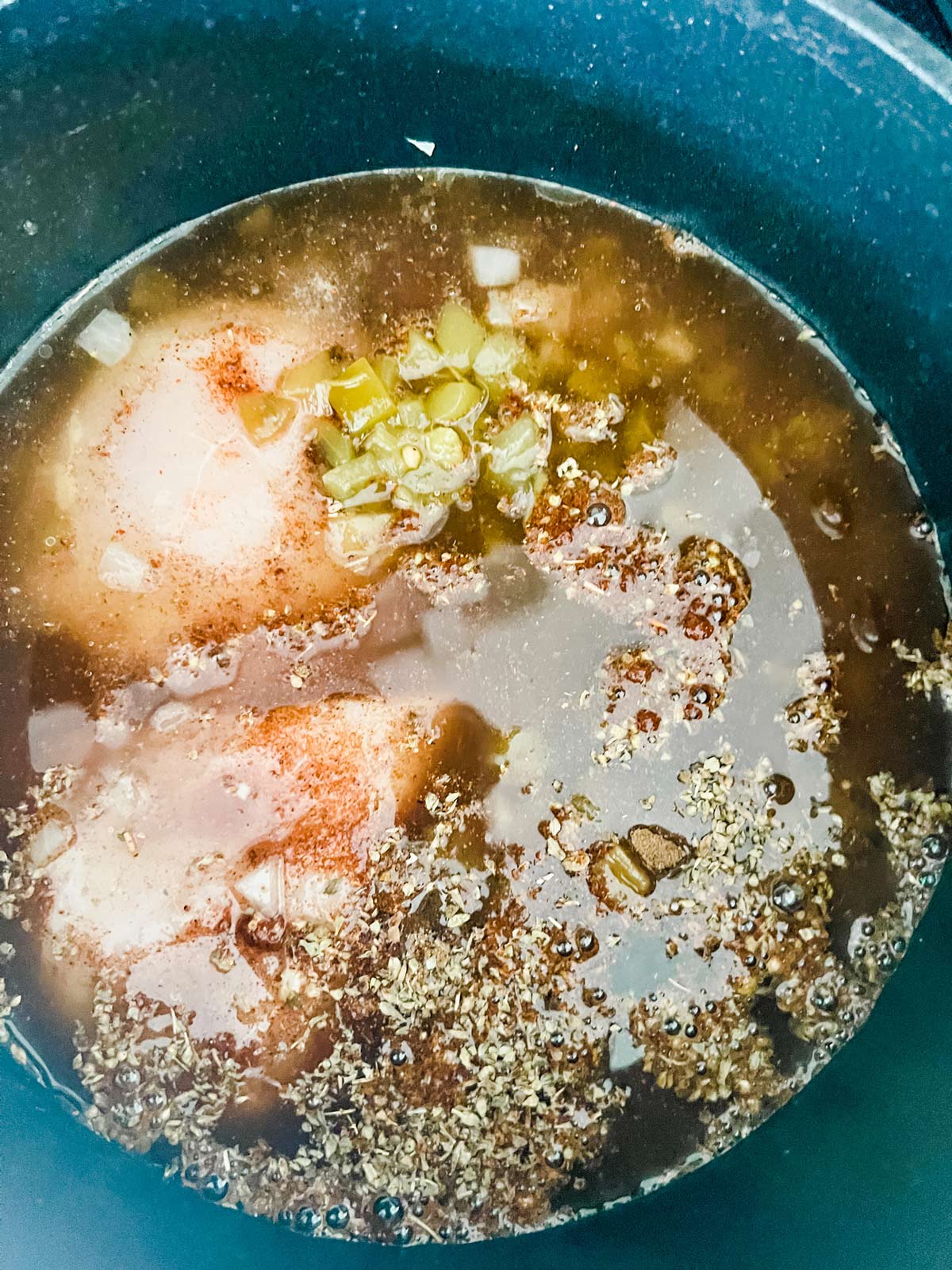 Overhead photo of keto white chili chicken cooking in a saucepan.
