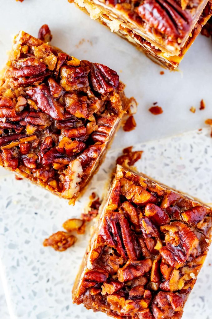 Overhead photo of a white marble board with keto pecan pie bars on it.