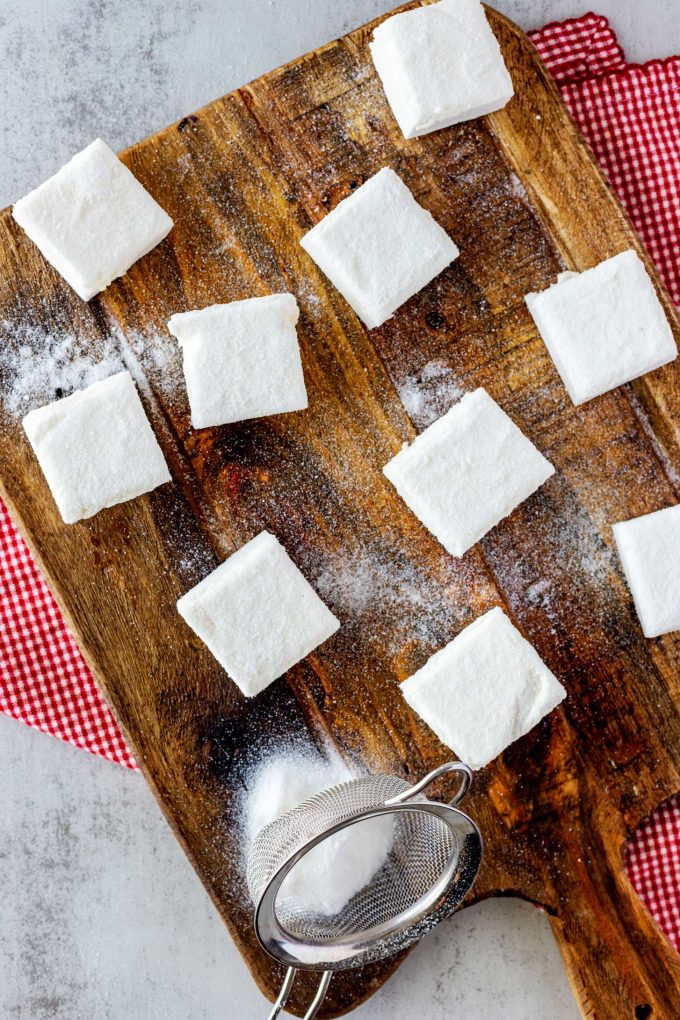Overhead photo of a wooden cutting board with keto marshmallows.