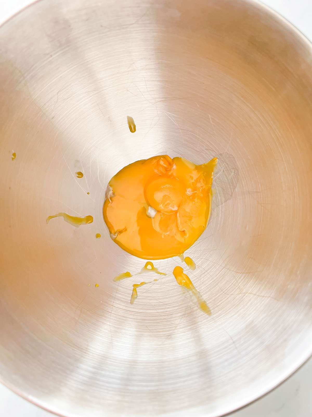 Egg yolks in the bowl of a stand mixer.
