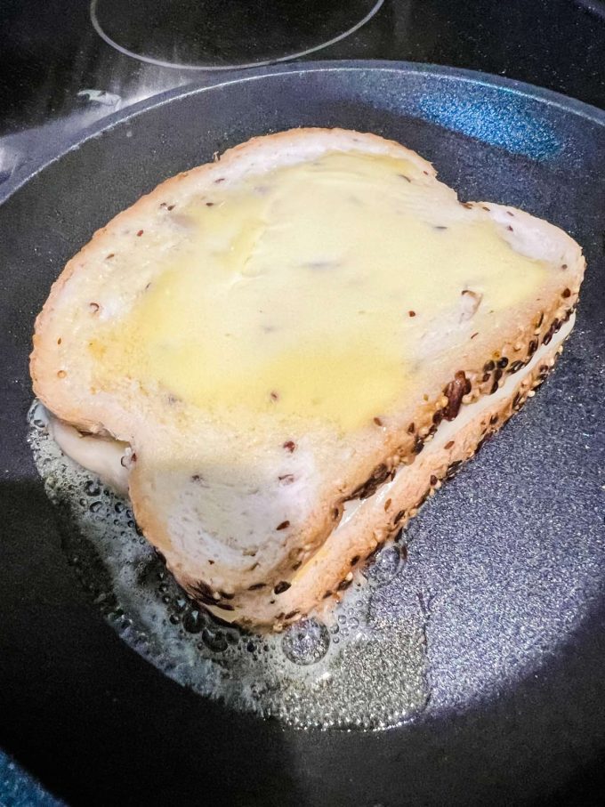 Photo of a keto grilled cheese cooking in a skillet.