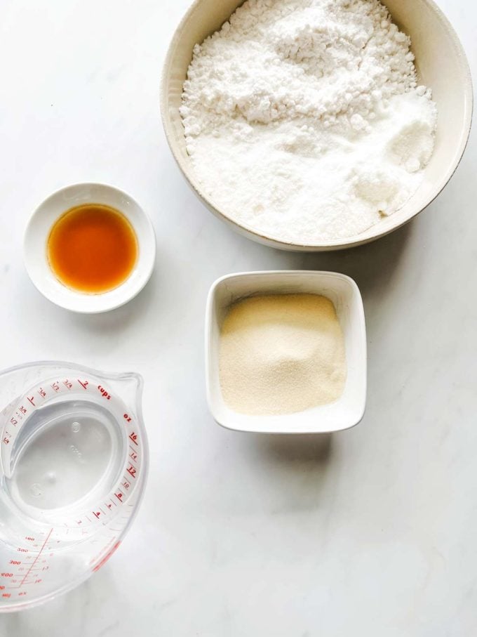 Overhead photo of water, gelatin, keto sweeteners, and vanilla in prep bowls.