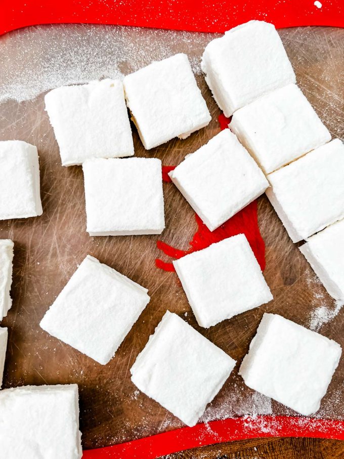 Cut keto marshmallows on a cutting board.