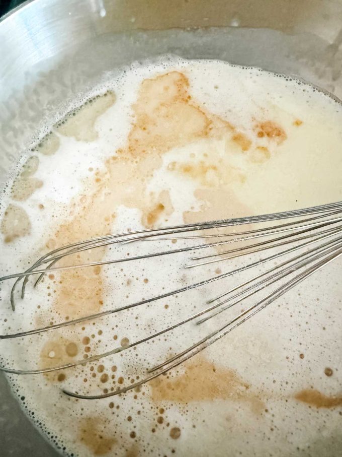 Photo of a creamy base for vanilla ice cream in a saucepan.